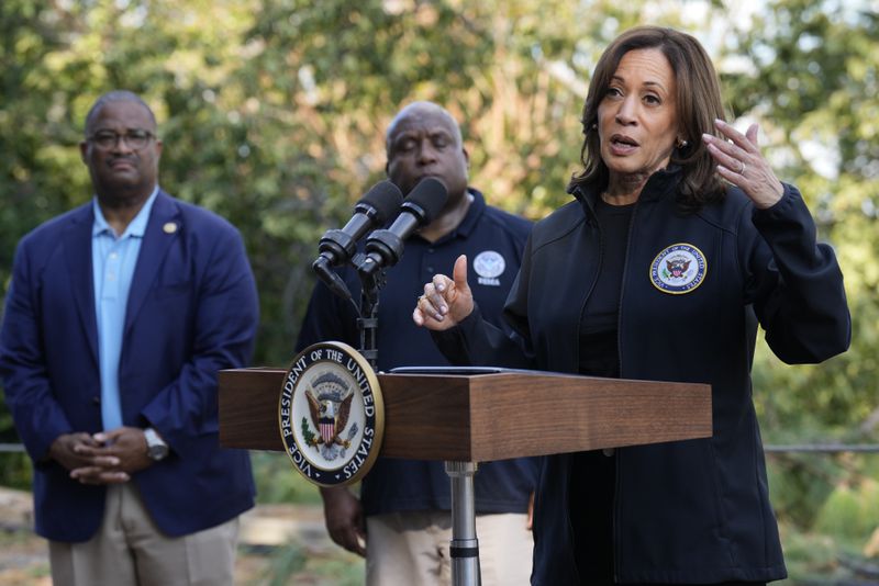 Democratic presidential nominee Vice President Kamala Harris speaks as she tours an area impacted by Hurricane Helene in Augusta, Ga., Wednesday, Oct. 2, 2024, as Augusta Mayor Garnett Johnson, left, and FEMA deputy director Erik Hooks listen. (AP Photo/Carolyn Kaster)