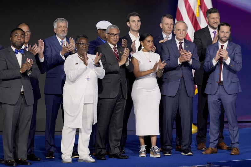 Democratic veterans serving in local, state and federal levels of government stand alongside Rep. Ruben Gallego, D-Ariz., during the Democratic National Convention Thursday, Aug. 22, 2024, in Chicago. (AP Photo/J. Scott Applewhite)