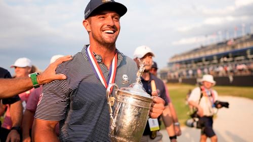 Bryson DeChambeau holds the trophy after winning the U.S. Open golf tournament Sunday, June 16, 2024, in Pinehurst, N.C. (AP Photo/Mike Stewart)