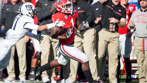 Georgia running back Sony Michel runs the ball past TCU cornerback Ranthony Texada in the Liberty Bowl on Friday. Michel rushed for 87 yards and scored two touchdowns in the Bulldogs’ 31-23 win over the Horned Frogs. (Michael Chang/Getty Images)