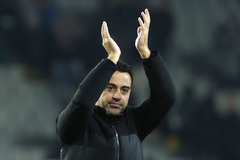 FILE - Barcelona's head coach Xavi Hernandez celebrates after the Spanish La Liga soccer match between Barcelona and Atletico Madrid at the Olimpic Lluis Companys stadium in Barcelona, Spain, on Dec. 3, 2023. Barcelona says coach Xavi Hernandez is leaving the club at the end of the season. The Spanish club made the announcement Friday May 24, 2024 after a meeting between club president Joan Laporta, Xavi and several other senior figures at the team's training ground. (AP Photo/Joan Monfort, File)