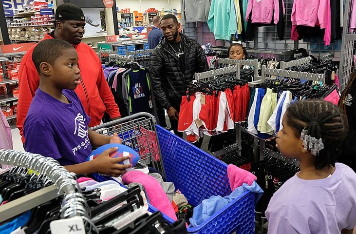 UGA Quarterback Carson Beck was on site at an Athen Academy store Sunday December 17, 2023, to give out gift cards to lucky members of area Boys and Girls Clubs. Academy Sports and Outdoors contributed $200 for each child and he kicked in $135 more of his own money to help families out. 

credit: Nell Carroll for the AJC