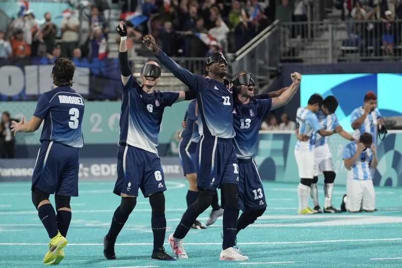 France players celebrate winning the blind football gold medal match at the 2024 Paralympics, Saturday, Sept. 7, 2024, in Paris, France. (AP Photo/Christophe Ena)