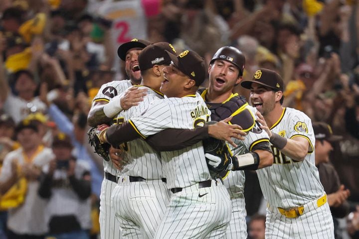 San Diego Padres’ Donovan Solano (39) embraces teammates after fielding the last out from Atlanta Braves’ Travis d'Arnaud to end National League Division Series Wild Card Game Two at Petco Park in San Diego on Wednesday, Oct. 2, 2024. Atlanta lost 5-4 allowing the Padres to advance to the Division Series and face the Los Angeles Dodgers.   (Jason Getz / Jason.Getz@ajc.com)