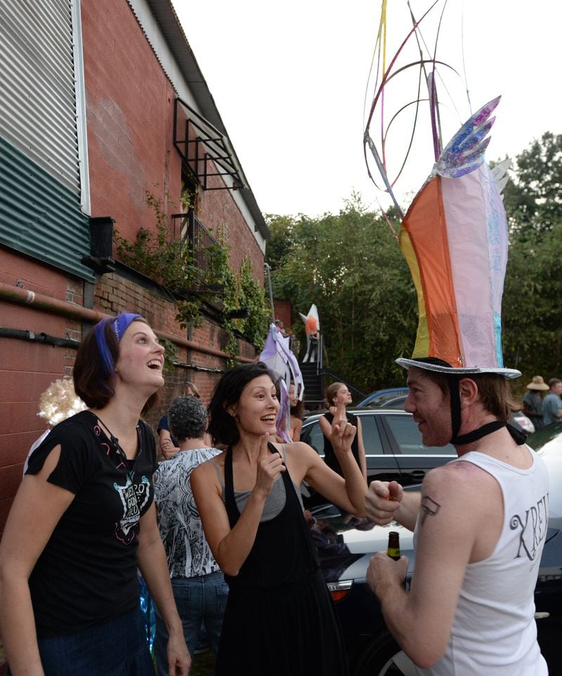 FILE: Thomas Hoomes (right) shows off his lantern hat as Heather Whitman (left) and Courtney Hartnett look during a tailgate line-up at Irwin Street and Krog Street before the 2013 Atlanta BeltLine Lantern Parade.