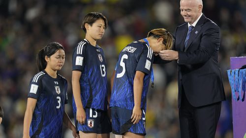 FIFA President Gianni Infantino, right, gives he second-place medal to Japan's Manaka Hayashi after her team lost the U-20 Women's World Cup final soccer match to North Korea at El Campin stadium in Bogota, Colombia, Sunday, Sept. 22, 2024. (AP Photo/Fernando Vergara)