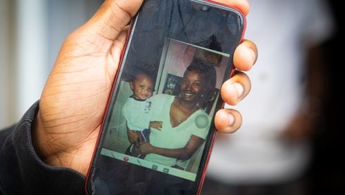 Christian Cardenas holds photo of himself and his mother Candi Shavon Miller who passed away from complications of abortion in the year of 2022. September 16th, 2024. Atlanta, GA