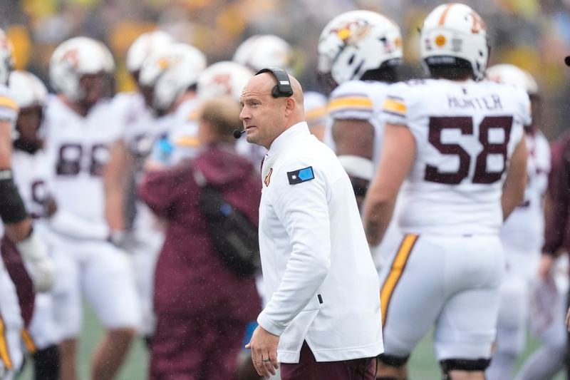 Minnesota head coach P.J. Fleck walks the sideline during the first half of an NCAA college football game against Michigan, Saturday, Sept. 28, 2024, in Ann Arbor, Mich. (AP Photo/Carlos Osorio)