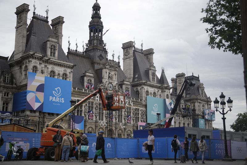 Construction barriers surround Hotel de Ville square, Wednesday, July 3, 2024 in Paris. Just three weeks before the Olympics, the excitement that was building up in the host city has mingled with anxiety about France’s political future. (AP Photo/Thibault Camus)