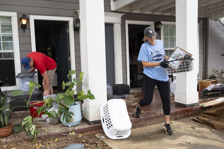 Dexter and Kerri Leach help their daughter move out of her flooded apartment at the Peachtree Park Apartments in Atlanta on Saturday, Sept. 28, 2024.   Ben Gray for the Atlanta Journal-Constitution