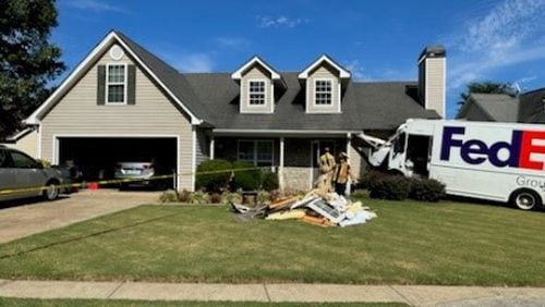 A home in Buford was structurally compromised after a FedEx truck crashed into it, seriously injuring its driver.