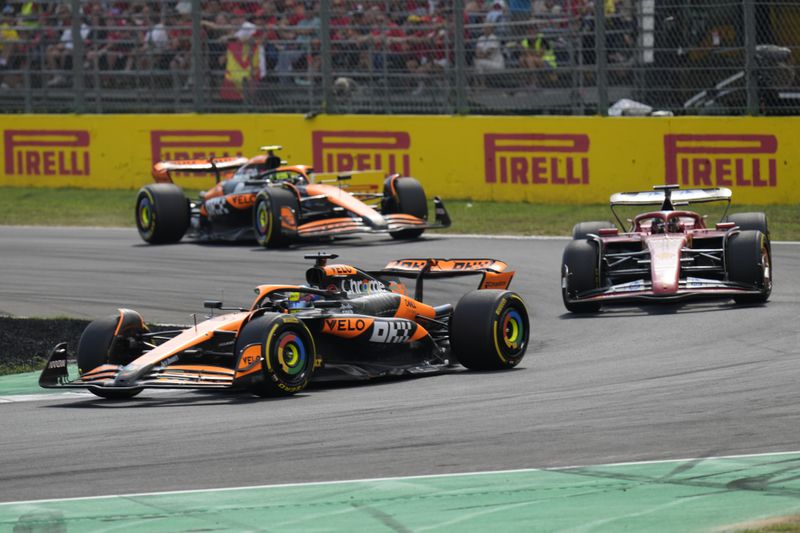 McLaren driver Oscar Piastri of Australia steers his car Ferrari driver Charles Leclerc of Monaco and McLaren driver Lando Norris of Britain during the Formula One Italian Grand Prix race at the Monza racetrack, in Monza, Italy, Sunday, Sept. 1, 2024. (AP Photo/Luca Bruno)