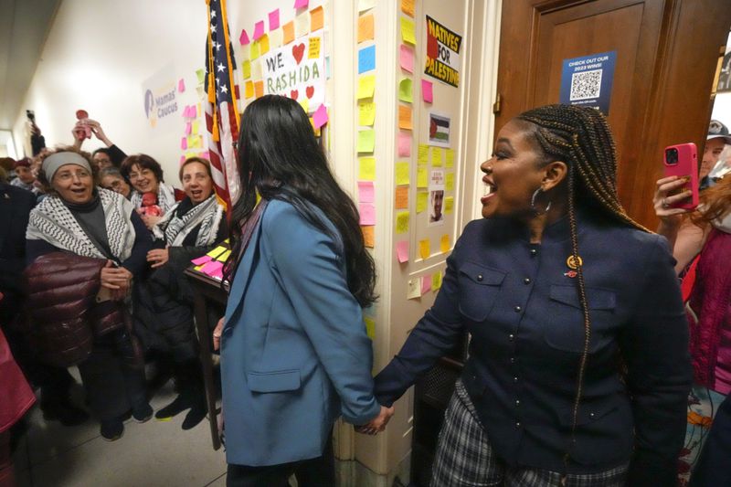 FILE - Rep. Cori Bush, D-Mo., from right, and Rep. Rashida Tlaib, D-Mich., come out of Tlaib's office to meet with activists from the group CodePink as they advocate for Gaza on Capitol Hill, Feb. 15, 2024, in Washington. Democratic lawmakers in the House and Senate are wrestling with whether to attend Israeli Prime Minister Benjamin Netanyahu's address to Congress on July 24, 2024. Netanyahu's visit to Capitol Hill is also expected to draw significant protests. Several groups, including some Jewish advocacy organizations, have demonstrated at congressional hearings and sit-ins outside of lawmakers' offices. (AP Photo/Mark Schiefelbein, File)