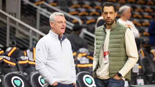 Atlanta Hawks owner Tony Ressler, left, and general manager Landry Fields talk before the Hawks’ game against the Cleveland Cavaliers at State Farm Arena, Friday, Feb. 24, 2023, in Atlanta. Jason Getz / Jason.Getz@ajc.com)