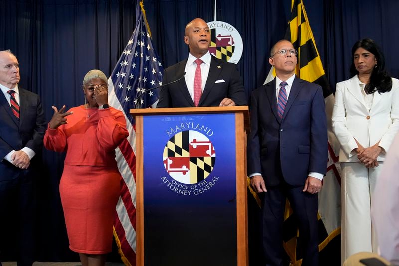 Maryland Gov. Wes Moore, center, speaks during a news conference announcing a lawsuit seeking damages from the owners and managers of the Dali cargo ship that crashed into the Francis Key Scott Bridge, Tuesday, Sept. 24, 2024, in Baltimore. (AP Photo/Stephanie Scarbrough)