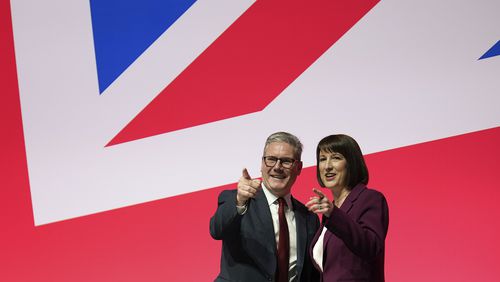 Britain's Prime Minister Keir Starmer and Britain's Chancellor of the Exchequer Rachel Reeves gesture after her speech at the Labour Party Conference in Liverpool, England, Monday, Sept. 23, 2024.(AP Photo/Jon Super)