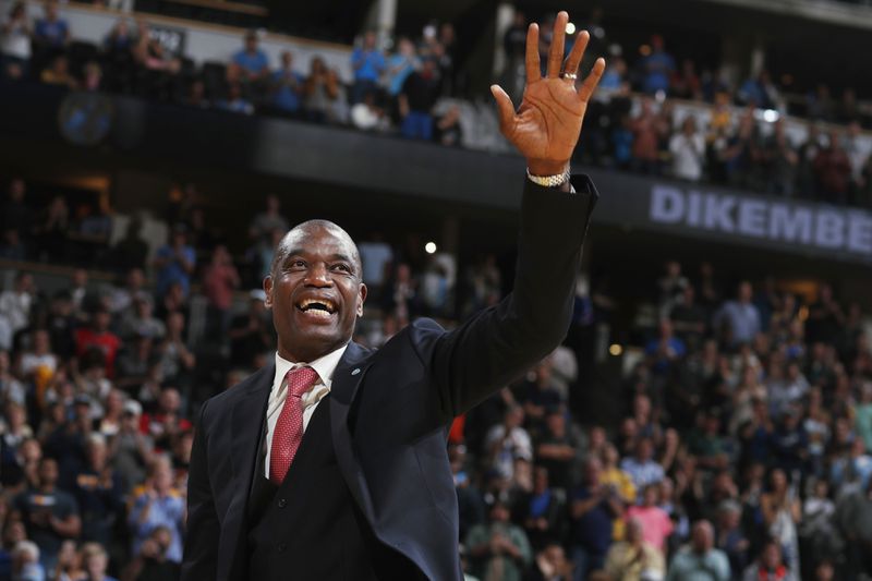 FILE - Retired Denver Nuggets center Dikembe Mutombo waves to the crowd as his jersey number was retired by the team during halftime of the Nuggets' NBA basketball game against the Portland Trail Blazers on Saturday, Oct. 29, 2016, in Denver. (AP Photo/David Zalubowski, File)