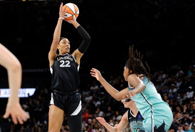 Las Vegas Aces center A'ja Wilson (22) shoots over New York Liberty forward Jonquel Jones, right, during the first half of a WNBA basketball game Saturday, Aug. 17, 2024, in Las Vegas. (Steve Marcus/Las Vegas Sun via AP)