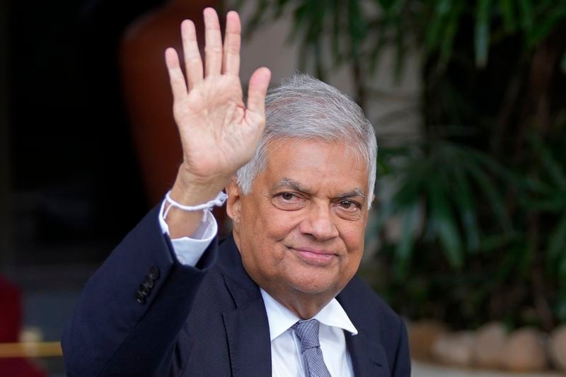 Sri Lanka's President Ranil Wickremesinghe waves to the media as he arrives to file his nomination for the upcoming presidential elections in Colombo, Sri Lanka, Thursday, Aug. 15, 2024. (AP Photo/Eranga Jayawardena, File)