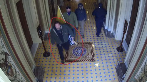 This image from U.S. Capitol Police video, released and annotated by the Justice Department in the statement of facts supporting an arrest warrant for Bradley Scott Nelson, shows Nelson, circled in red, at the U.S. Capitol on Jan. 6, 2021, in Washington. (Justice Department via AP)