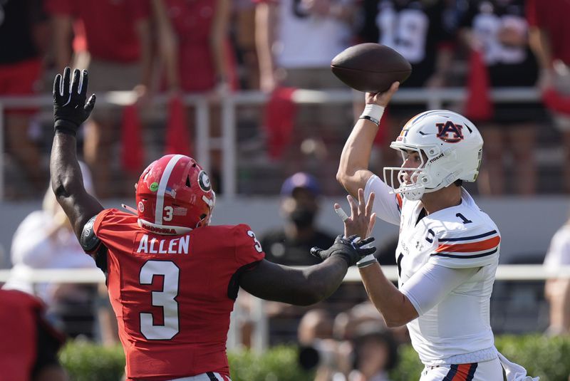 Auburn quarterback Payton Thorne (1) throws under pressure from Georgia linebacker CJ Allen (3) in the first half of an NCAA college football game Saturday, Oct. 5, 2024, in Athens, Ga. (AP Photo/John Bazemore)