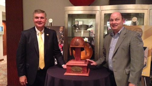 Georgia Tech coach Paul Johnson and Peach Bowl CEO Gary Stokan pose with the trophy for the Chick-fil-A Kickoff game at the ACC Kickoff in Charlotte, N.C., Friday. The game is to be played Sept. 4 between Tech and Tennessee at the Mercedes-Benz Stadium. (AJC photo by Ken Sugiura)