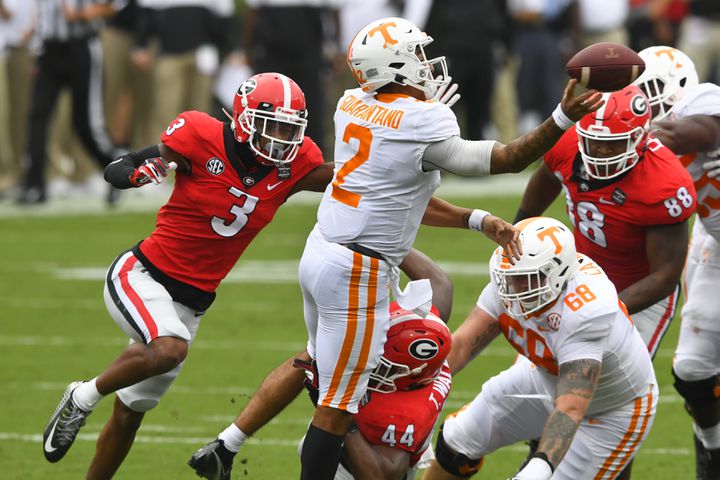 Georgia defensive back Tyson Campbell (3) bears down on Tennessee quarterback Jarrett Guarantano (2) as Georgia defensive lineman Travon Walker (44) tries to bring him down from below during the first half of a football game Saturday, Oct. 10, 2020, at Sanford Stadium in Athens. JOHN AMIS FOR THE ATLANTA JOURNAL- CONSTITUTION