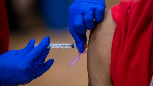 02/10/2021 —Atlanta, Georgia — A COVID-19 vaccination is administered during a DeKalb County Board of Health and Delta Sigma Theta Sorority, Inc. COVID-19 vaccination event at the Lou Walker Senior Center in Stonecrest, Wednesday, February 10, 2021. (Alyssa Pointer / Alyssa.Pointer@ajc.com)