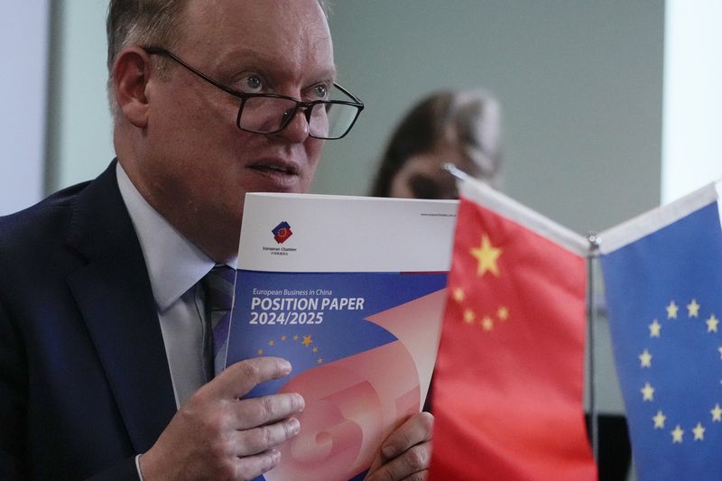 President of the European Union Chamber of Commerce in China Jens Eskelund holds a copy of the annual European Business in China Position Paper during a press conference in Beijing, Wednesday, Sept. 11, 2024. (AP Photo/Andy Wong)