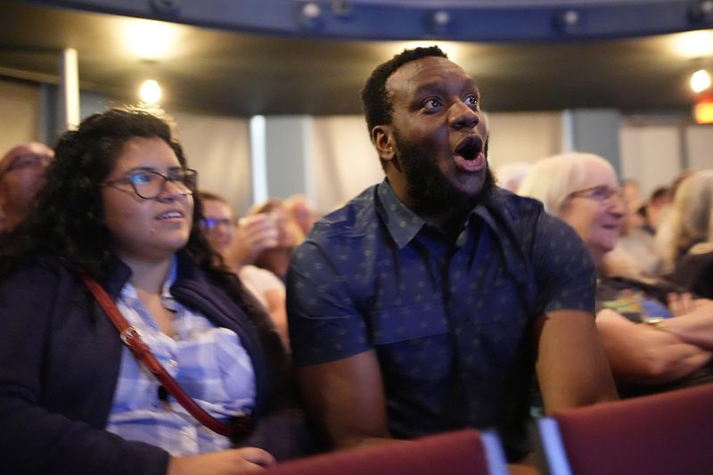 Ikenna Amilo, center, reacts to a comment by Republican presidential nominee former President Donald Trump during a presidential debate with Democratic presidential nominee Vice President Kamala Harris, Tuesday, Sept. 10, 2024, in Portland, Maine. (AP Photo/Robert F. Bukaty)