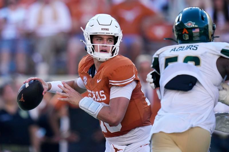 Texas quarterback Arch Manning, left, throws against Colorado State during the second half of an NCAA college football game in Austin, Texas, Saturday, Aug. 31, 2024. (AP Photo/Eric Gay)