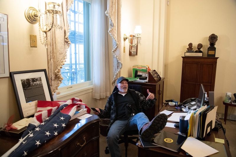 A supporter of U.S. President Donald Trump sits inside the office of U.S. Speaker of the House Nancy Pelosi as he protests inside the U.S. Capitol in Washington, D.C., on Wednesday, Jan. 6, 2021. Demonstrators breeched security and entered the Capitol as Congress debated the a 2020 presidential election Electoral Vote Certification. (Saul Loeb/AFP/Getty Images/TNS)