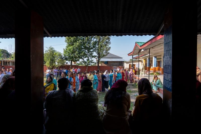 Women stand in a queue to cast their vote in the seventh and last round of polling in India's national election in Dharamshala, India, Saturday, June 1, 2024. (AP Photo/Ashwini Bhatia)