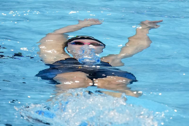 Claire Curzan swims during a Women's 100 backstroke preliminary heat Monday, June 17, 2024, at the US Swimming Olympic Trials in Indianapolis. (AP Photo/Michael Conroy)