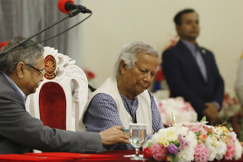 FILE -Nobel laureate Muhammad Yunus signs a document after taking the oath of office as the head of Bangladesh's interim government, in Dhaka, Bangladesh, Aug. 8, 2024. (AP Photo/Rajib Dhar, File)