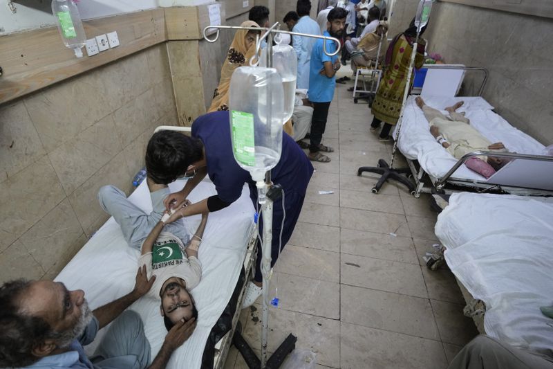 Patients of heatstroke receive treatment at a hospital in Karachi, Pakistan, Tuesday, June 25, 2024. Various parts of the country continued to experience an intense heat wave conditions, with the temperatures reaching 47 degree Celsius (116.6 Fahrenheit) in Nawabshah and other cities, according to the press release of Pakistan Meteorological Department. (AP Photo/Fareed Khan)