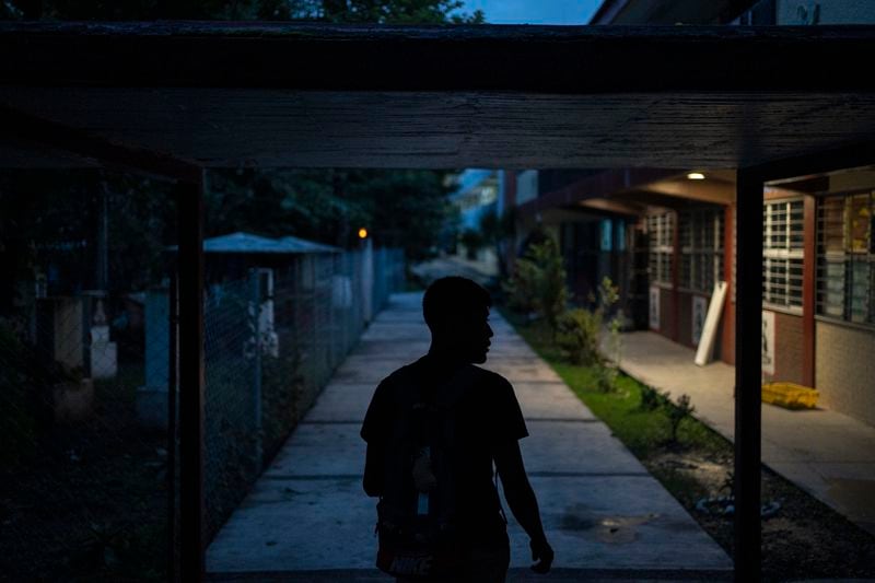 A student walks on the campus of the Raúl Isidro Burgos Rural Normal School in Ayotzinapa, Guerrero state, Mexico, late Sunday, Aug. 25, 2024. (AP Photo/Felix Marquez)