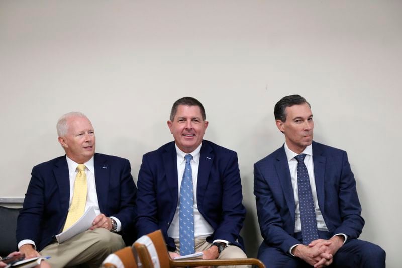 Santee Cooper CEO Jimmy Staton, left, Dominion Energy South Carolina President Keller Kissam, center, and Duke Energy's utility operations in South Carolina President Mike Callahan, right, wait to testify before a South Carolina Senate committee planning to write a comprehensive energy bill in 2025 in Columbia, S.C., on Thursday, Aug. 22 2024. (AP Photo/Jeffrey Collins)