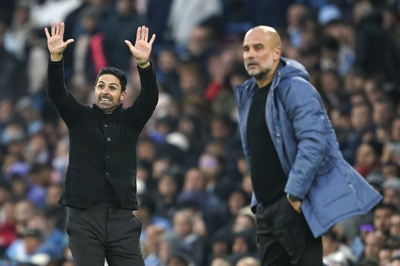 Arsenal's manager Mikel Arteta, left, gestures as he stands on the touchline next to Manchester City's head coach Pep Guardiola during the English Premier League soccer match between Manchester City and Arsenal at the Etihad stadium in Manchester, England, Sunday, Sept. 22, 2024. (AP Photo/Dave Thompson)