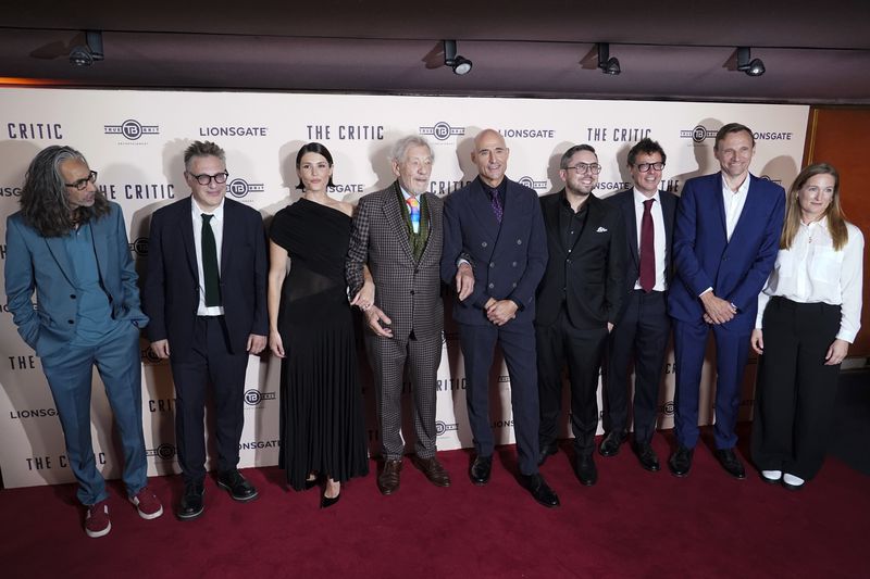 Ian McKellen, with Gemma Arterton, at centre, with cast members as they pose for photographers upon arrival at the European Premiere of the The Critic, In London, Monday, Sept. 2, 2024. (AP Photo/Alberto Pezzali)