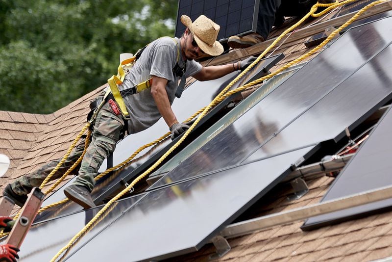 Alternative Energy Southeast employee Aaron Basto installs eighteen solar panels on the roof of a residence on Tuesday, June 7, 2022, in Ellenwood, Ga. Solar projects of all sizes have been affected by recent supply chain disruptions. (Jason Getz / Jason.Getz@ajc.com)