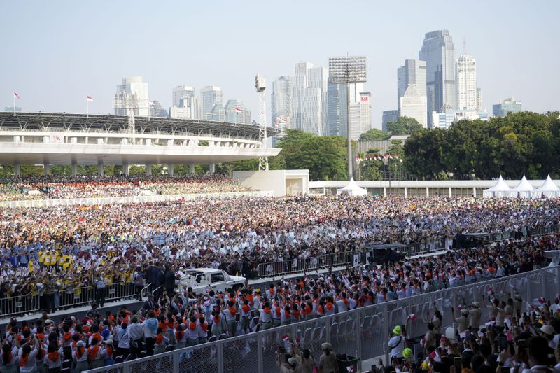 The crowd greets Pope Francis as he arrives at Madya Stadium in Jakarta, Indonesia, Thursday, Sept. 5, 2024. (AP Photo/Tatan Syuflana)