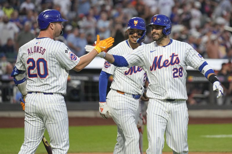 New York Mets' J.D. Martinez, right, celebrates his two-run homer with Pete Alonso (20), left, and Mark Vientos, center, during the first inning of a baseball game against the Baltimore Orioles at Citi Field, Monday, Aug. 19, 2024, in New York. (AP Photo/Seth Wenig)