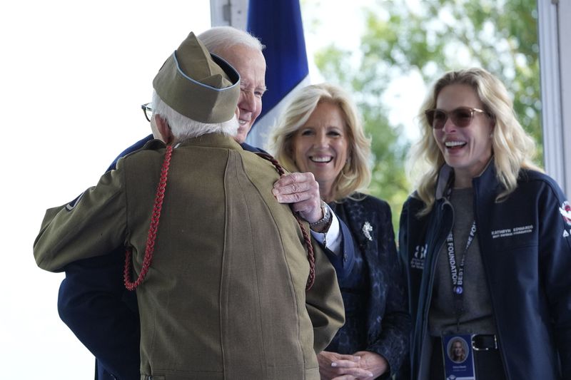 President Joe Biden and first lady Jill Biden greet a World War II veteran during ceremonies today to mark the 80th anniversary of D-Day in Normandy.