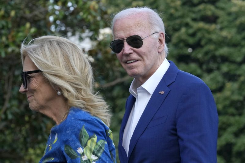 President Joe Biden smiles as he is asked questions by members of the media as he and first lady Jill Biden return on Marine One on the South Lawn of the White House in Washington on Sunday, July 7, 2024, after attending events in Pennsylvania. (AP Photo/Susan Walsh)