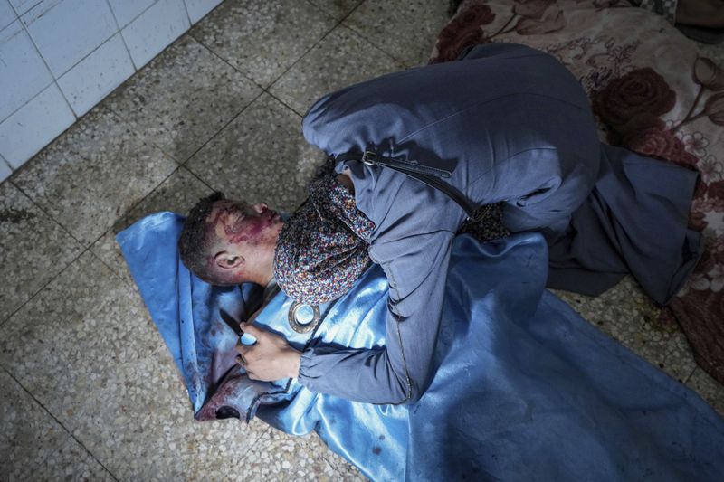 A Palestinian woman mourns over the body of her nephew, Hamza Al Raei, 11, killed in the Israeli bombardment of the Gaza Strip in a hospital in Deir al Balah on Tuesday, June 18, 2024. (AP Photo/Abdel Kareem Hana)