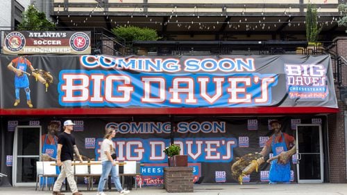 People walk by the new Big Dave’s Cheesesteaks flagship location on Marietta street in Atlanta on Monday, July 29, 2024.  The previous downtown location closed following water main breaks in June that caused damage to several businesses. (Arvin Temkar / AJC)