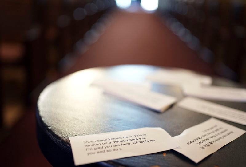 Cards printed in both Creole and English display a message of support for Haitians that reads, "I'm glad you are here. Christ loves you and so do I," near the altar at Central Christ Church after a service Sunday, Sept. 15, 2024, in Springfield, Ohio. (AP Photo/Luis Andres Henao)