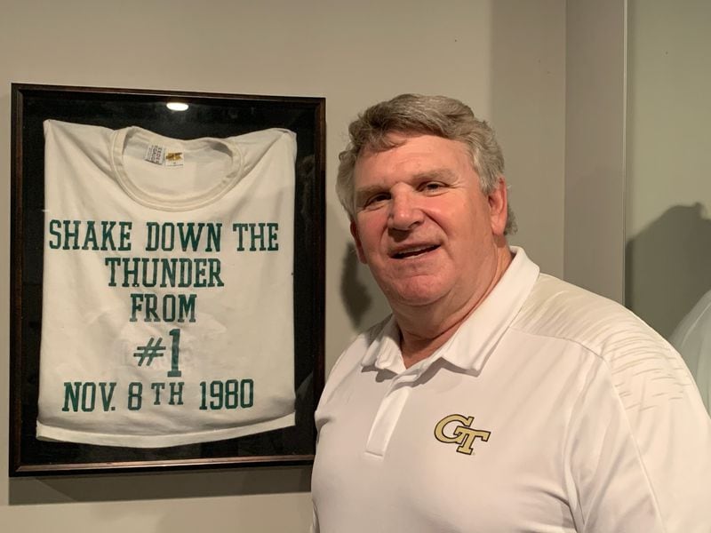 Former Georgia Tech football player Steve Mooney with the T-shirt given to players the week of their game with Notre Dame on Nov. 3, 1980. Mooney keeps the shirt in his home gym.