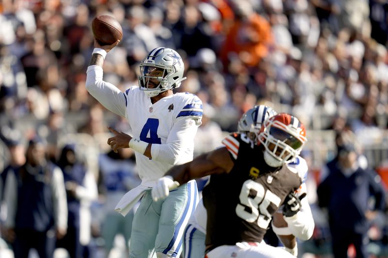 Dallas Cowboys quarterback Dak Prescott (4) throws a pass under pressure from Cleveland Browns defensive end Myles Garrett (95) in the first half of an NFL football game in Cleveland, Sunday, Sept. 8, 2024. (AP Photo/Sue Ogrocki)